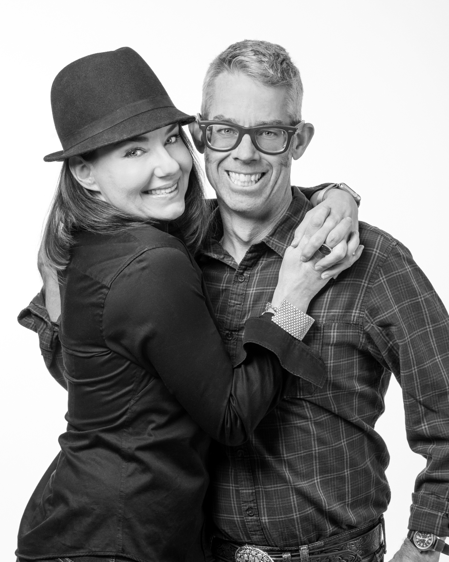 Black & white studio portrait of hip young married couple
