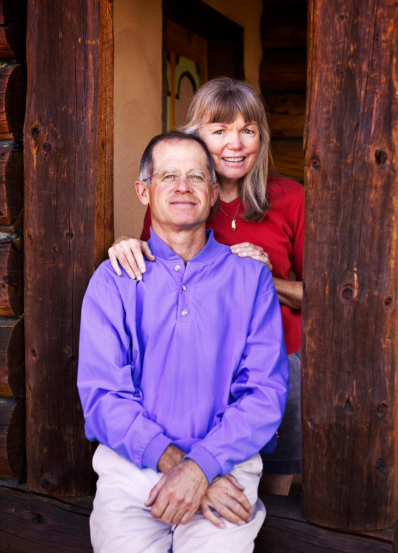 Portrait of middle aged couple outside their Taos, New Mexico, home.