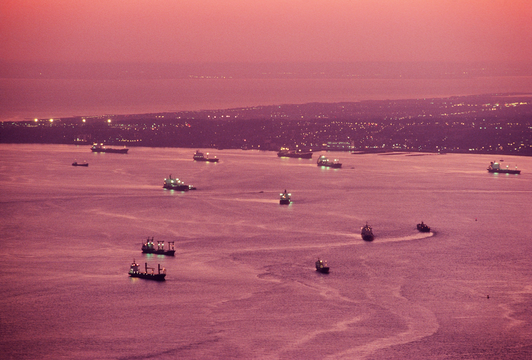 Aerial view of pink sunset sky reflected in New York Harbor; New York; USA