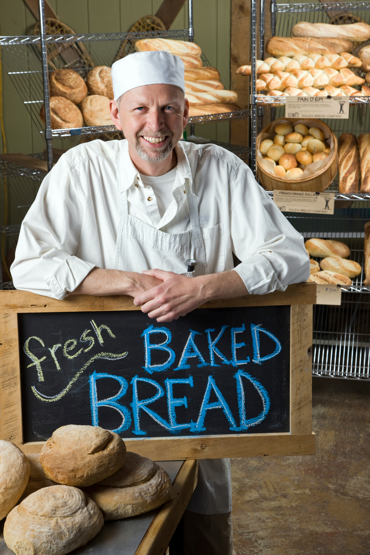 Professional cook preparing fresh bread in a commercial bakery