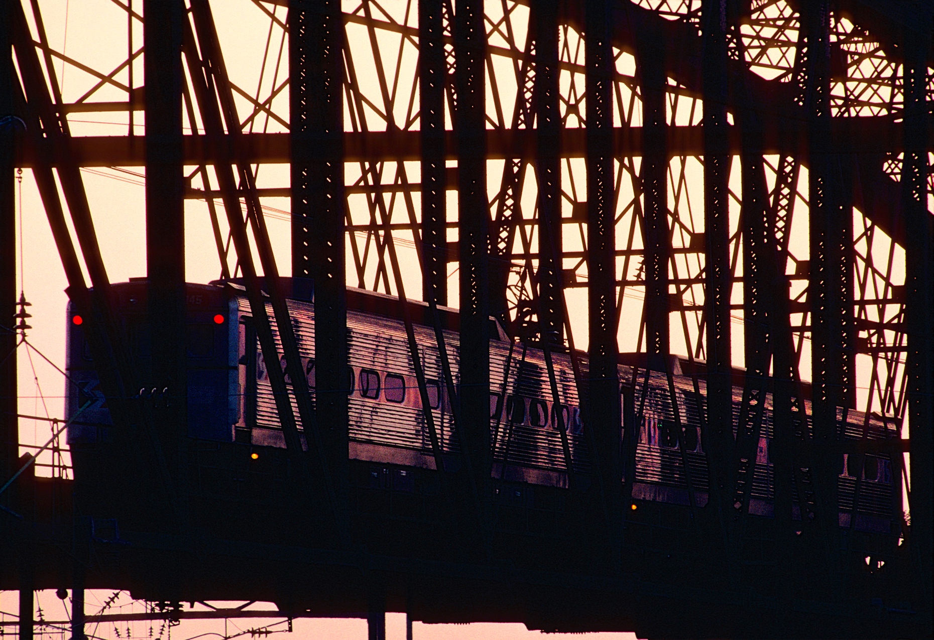 SEPTA commuter train crossing bridge in West Philadelphia; Pennsylvania; at dusk