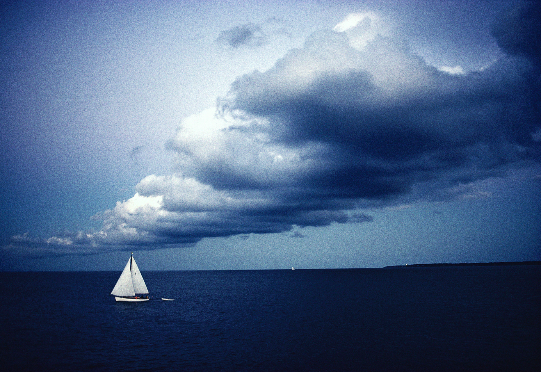 Dramatic dusk sky and sailboat off Martha