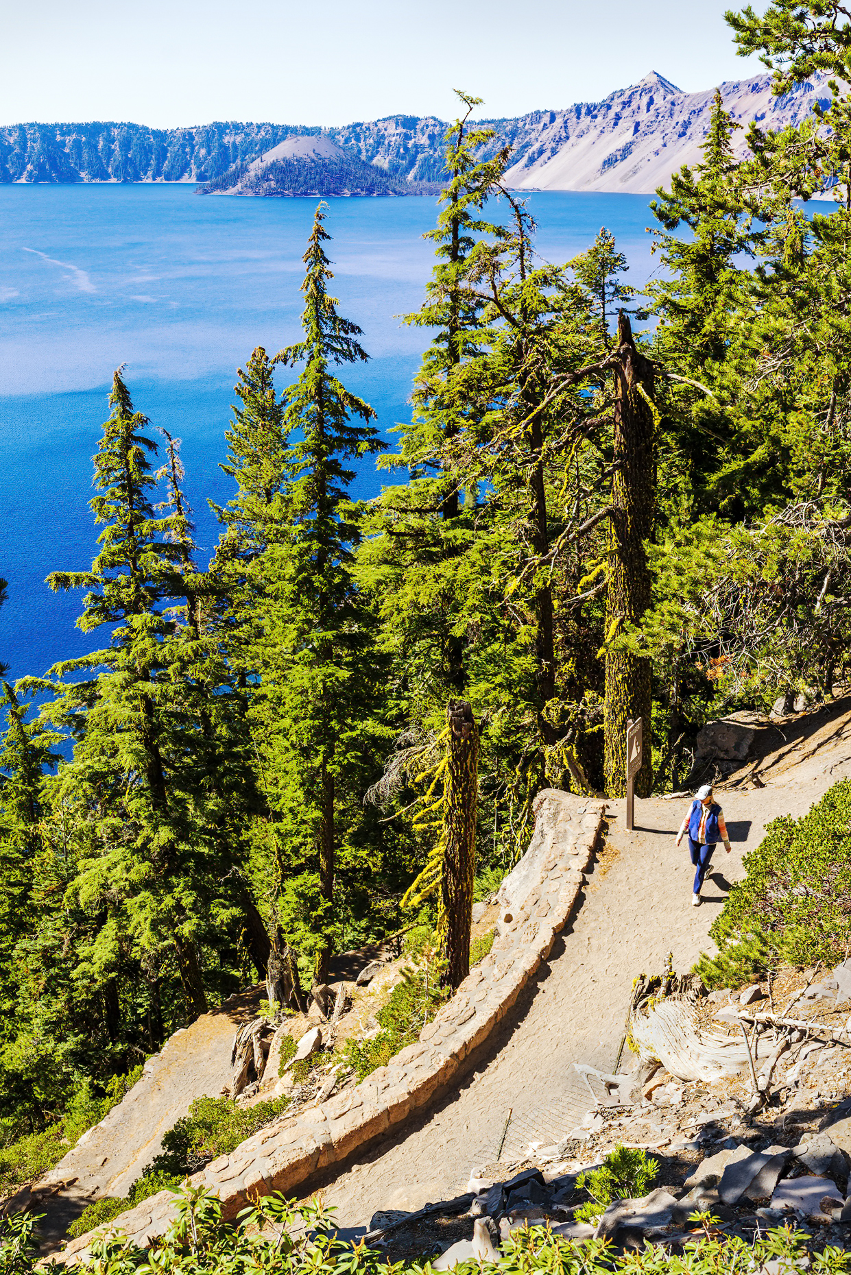 Woman hiking trail; Crater Lake National Park; Cascade Mountains; eastern Oregon; USA