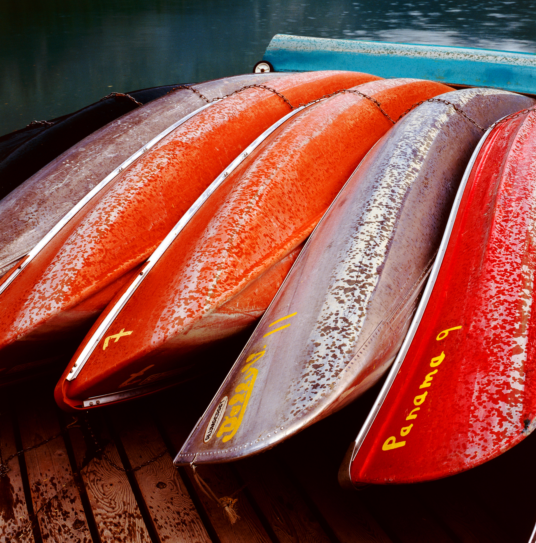 Colorful canoes on the dock in rain, Emerald Lake, Yoho National