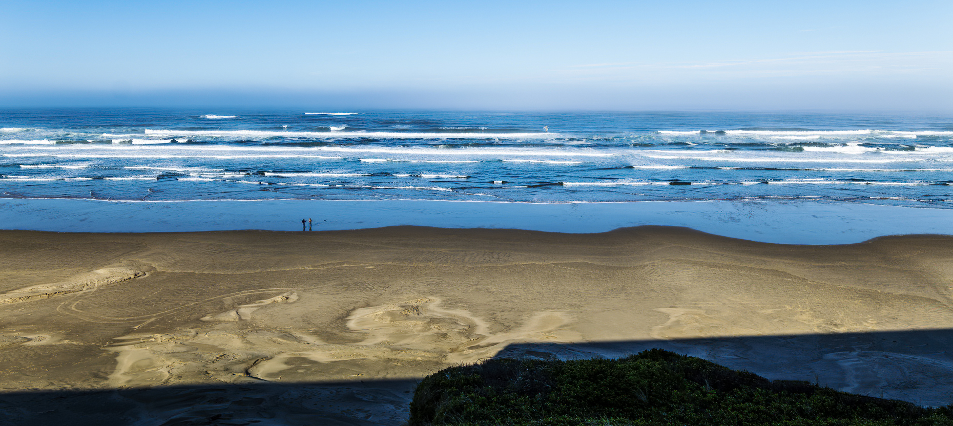 Panorama view of visitors walking the beach; Pacific Ocean; Oreg