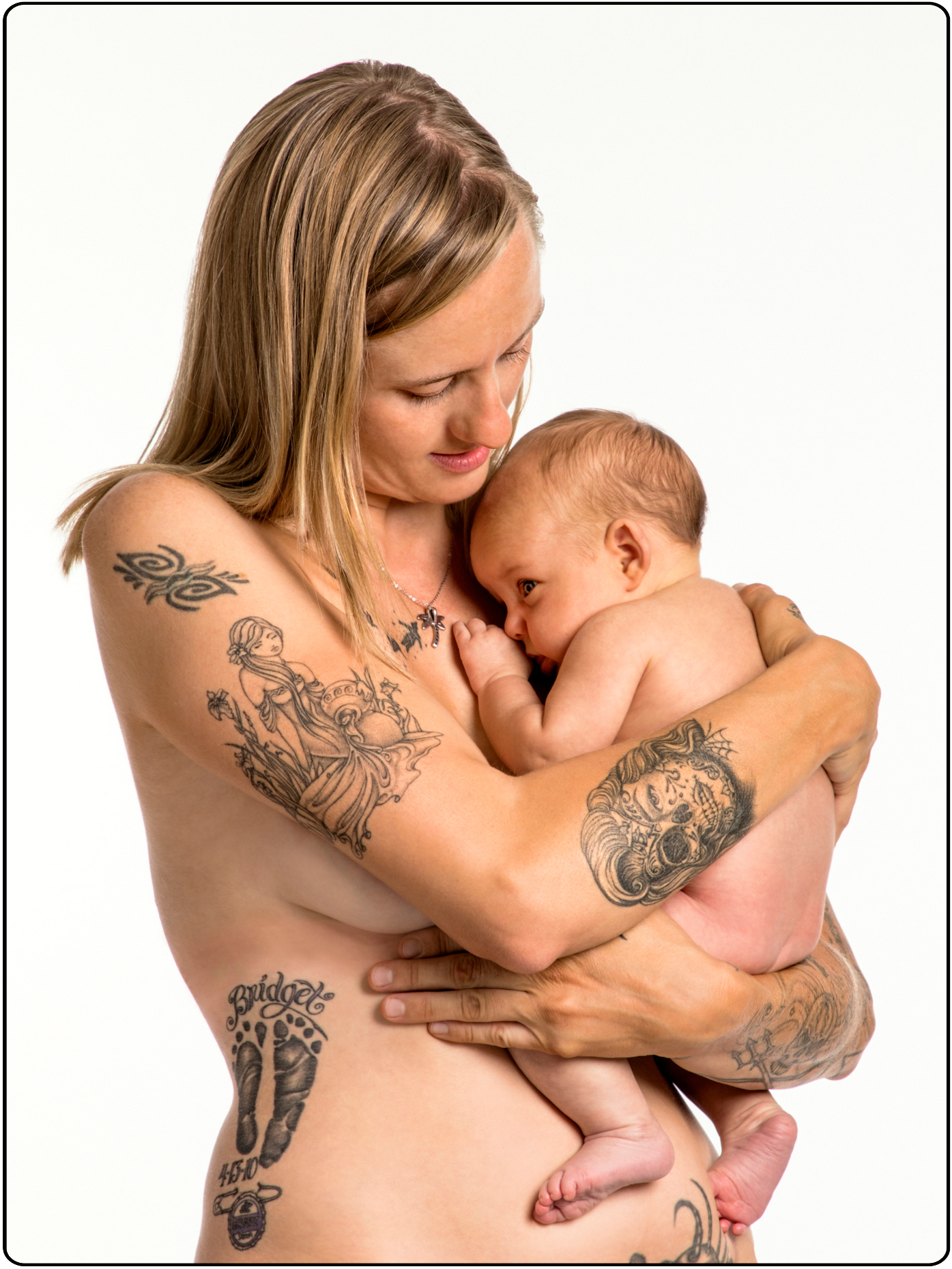 Attractive tattooed young mother with seven week baby girl