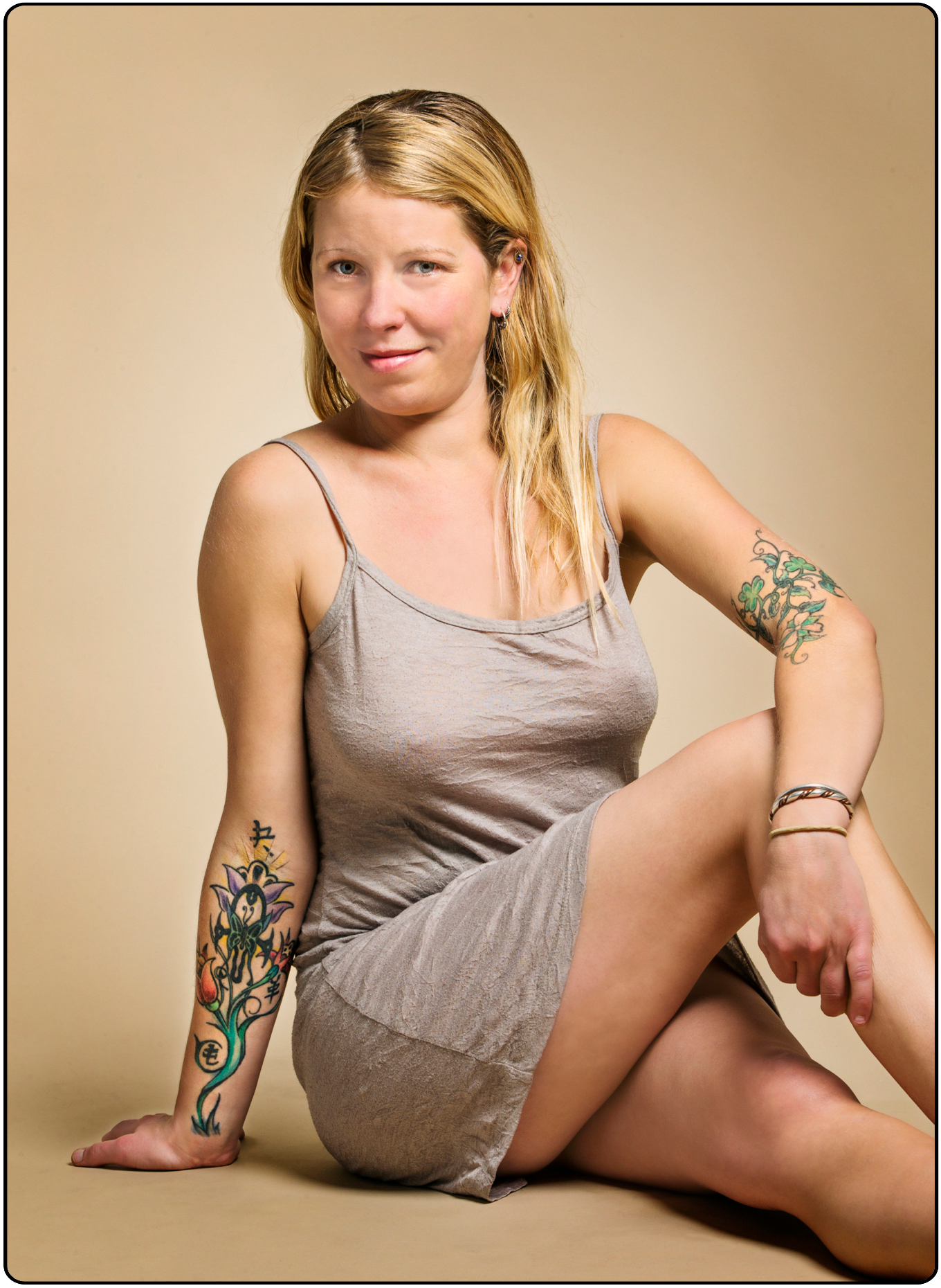 Studio portrait of tattoos on an attractive young blonde haired Caucasian woman