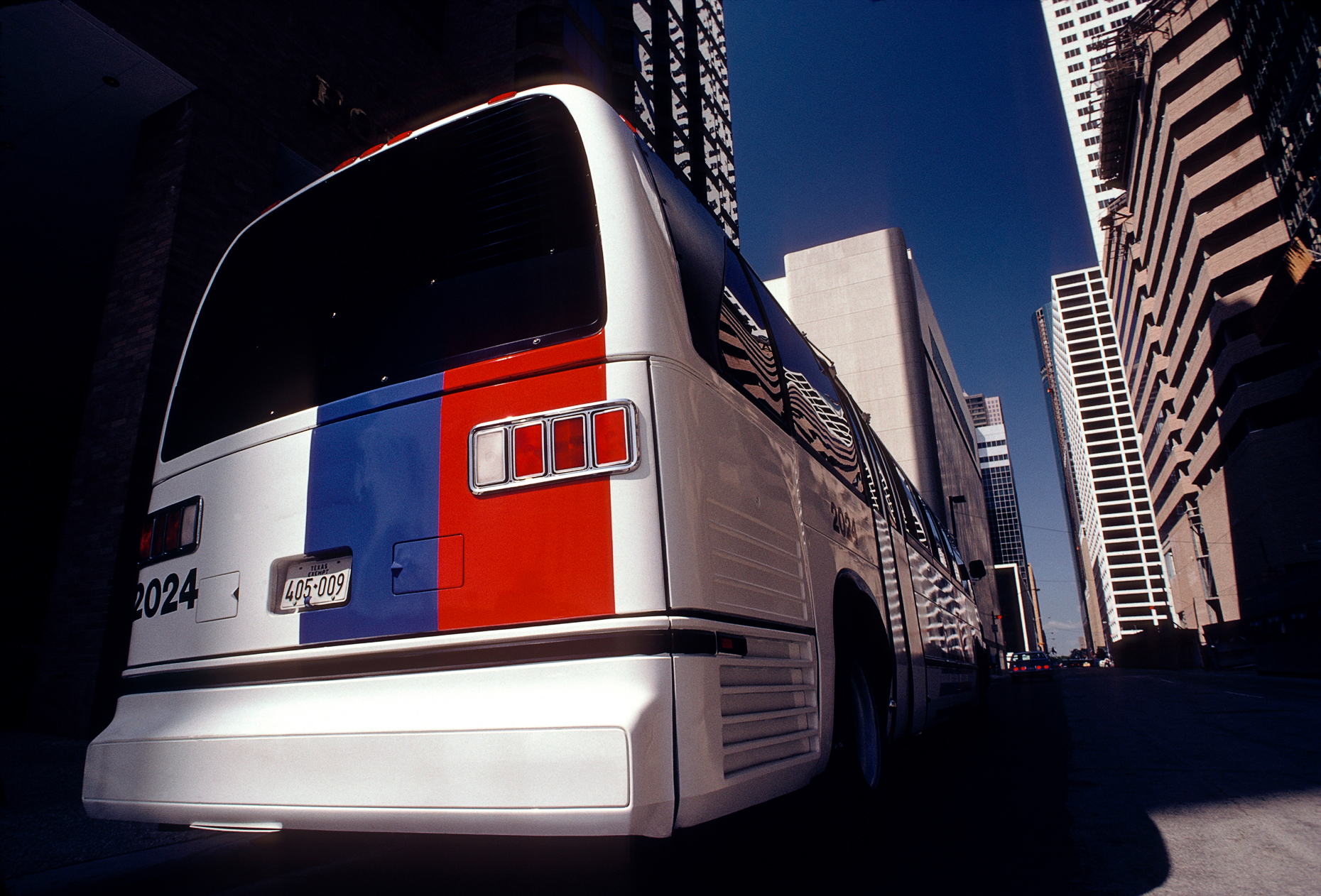 Rear view of a colorful red white & blue bus, Metropolitan Trans