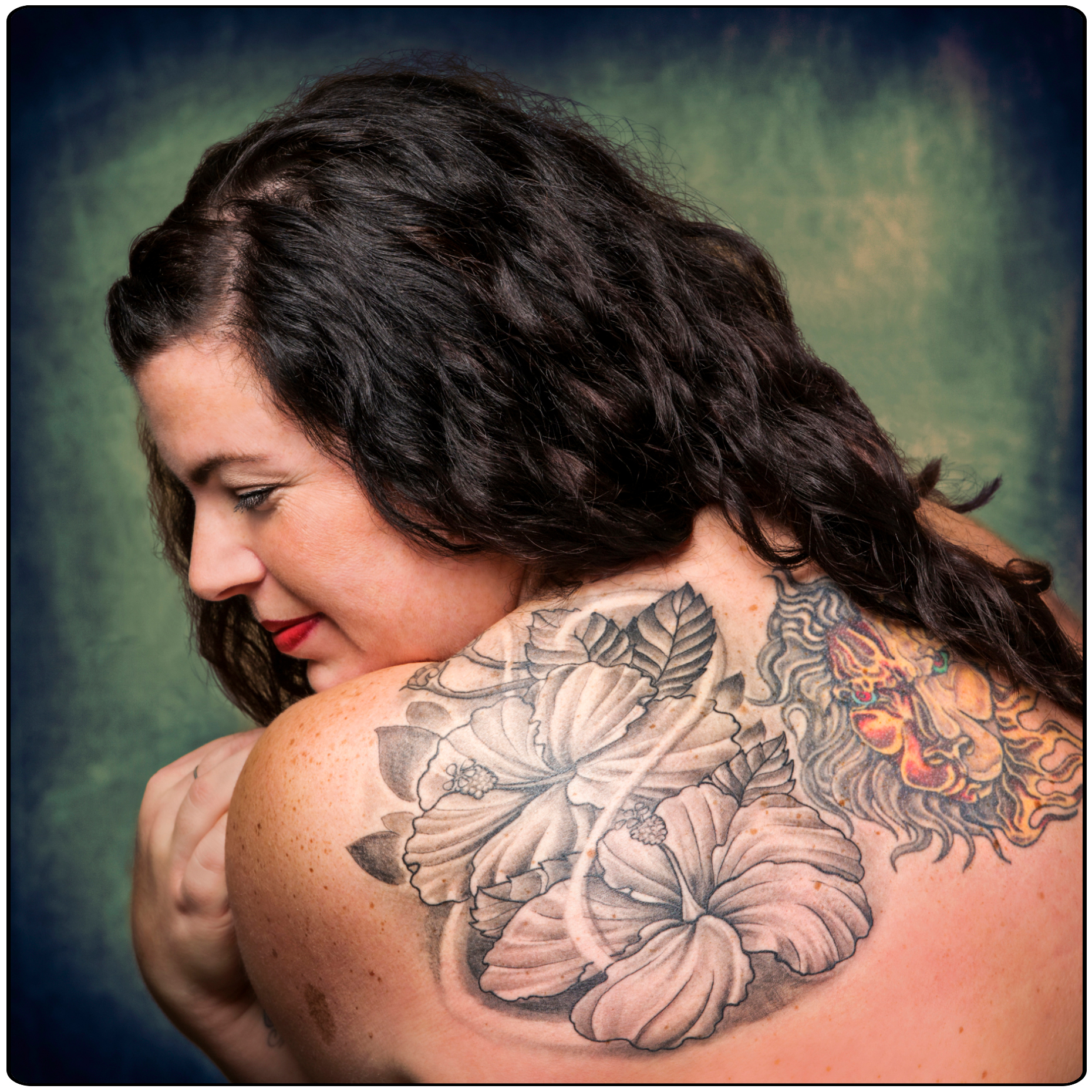 Studio portrait of tattoos on a nude woman