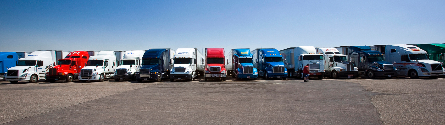 Over-the-road tractor trailer rigs parked at a Travel America truck stop, Interstate 70, Limon, Colorado, USA