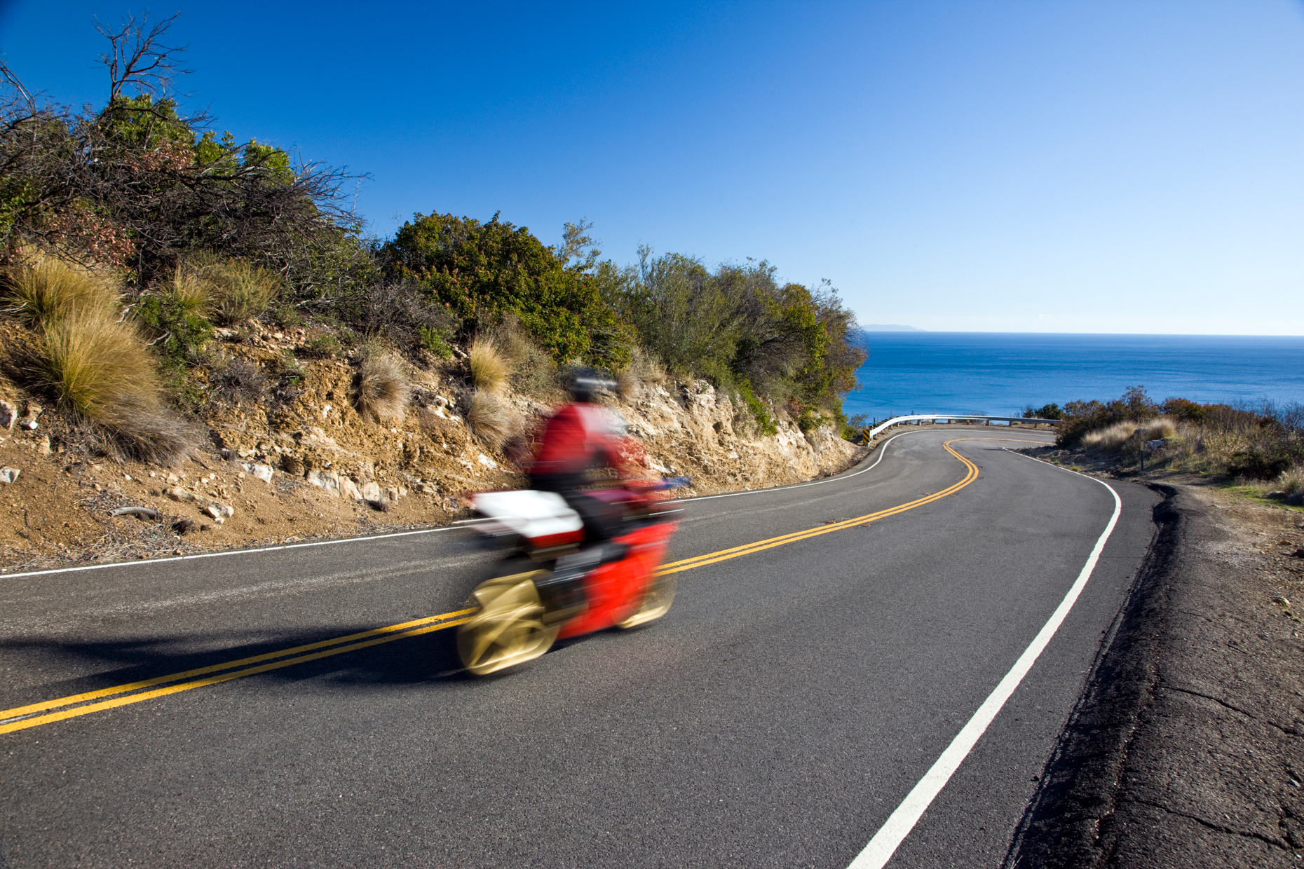 Action blur of a motorcycle rider on a road near Rt. 1 and Malibu, California, USA