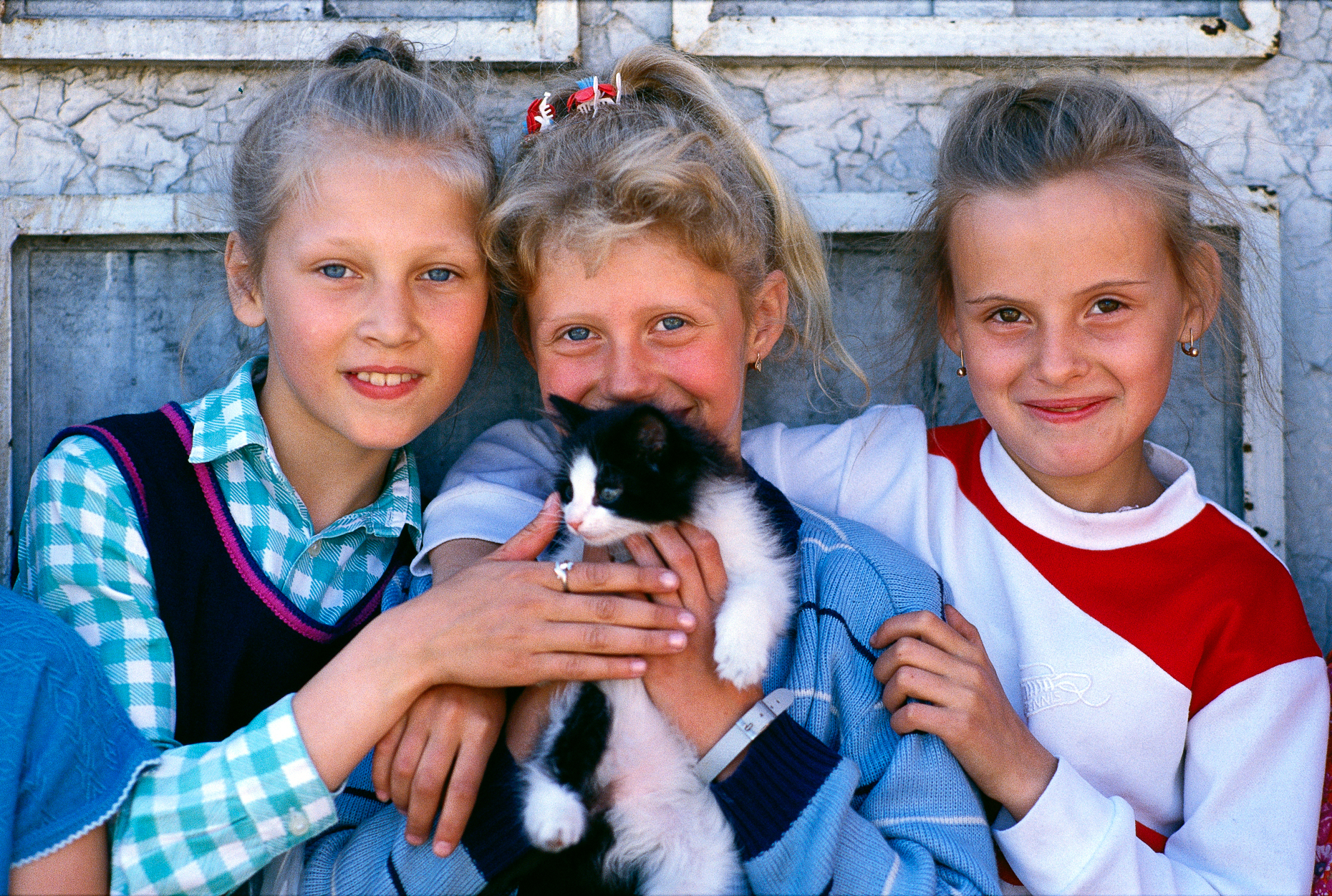Three young girls and a kitten, Egvekinot, small coastal town on the Bering Sea, Magadan Region, Chukchi Peninsula, USSR (former)