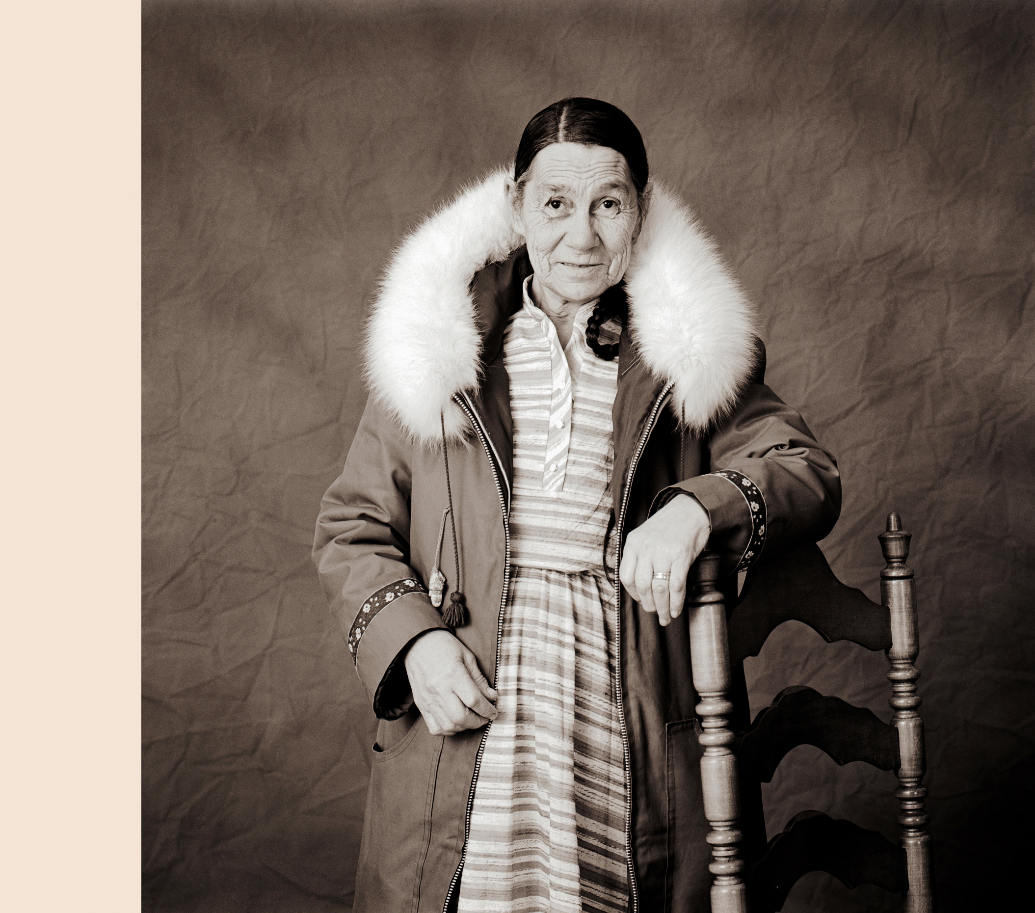 Black & white studio portrait of Inuit woman wearing a traditional parka in a photography studio in Iqaluit, Nunavut, Canada