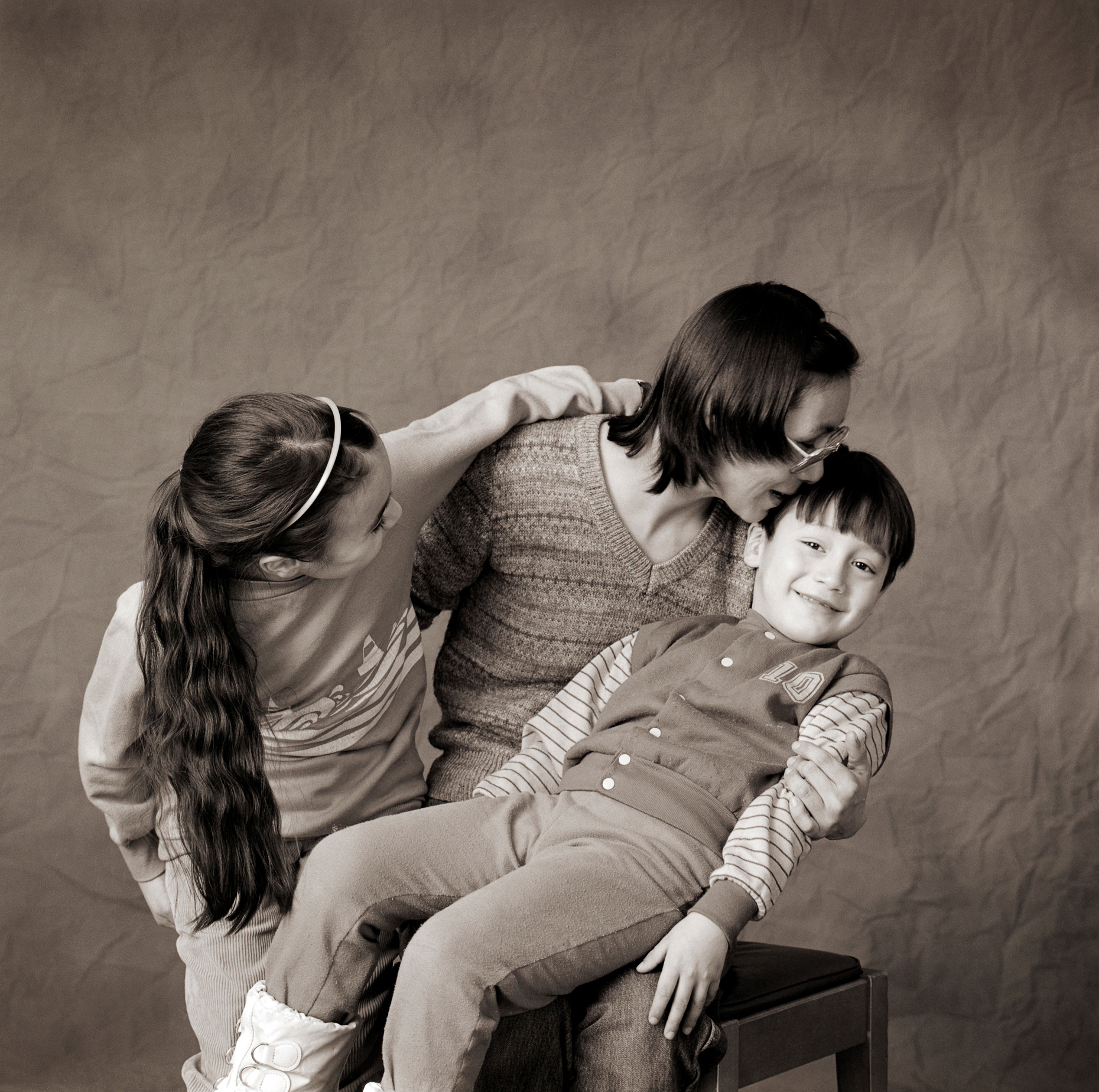 Black & white studio portrait of Inuit woman and her two children in a photography studio in Iqaluit, Nunavut, Canada