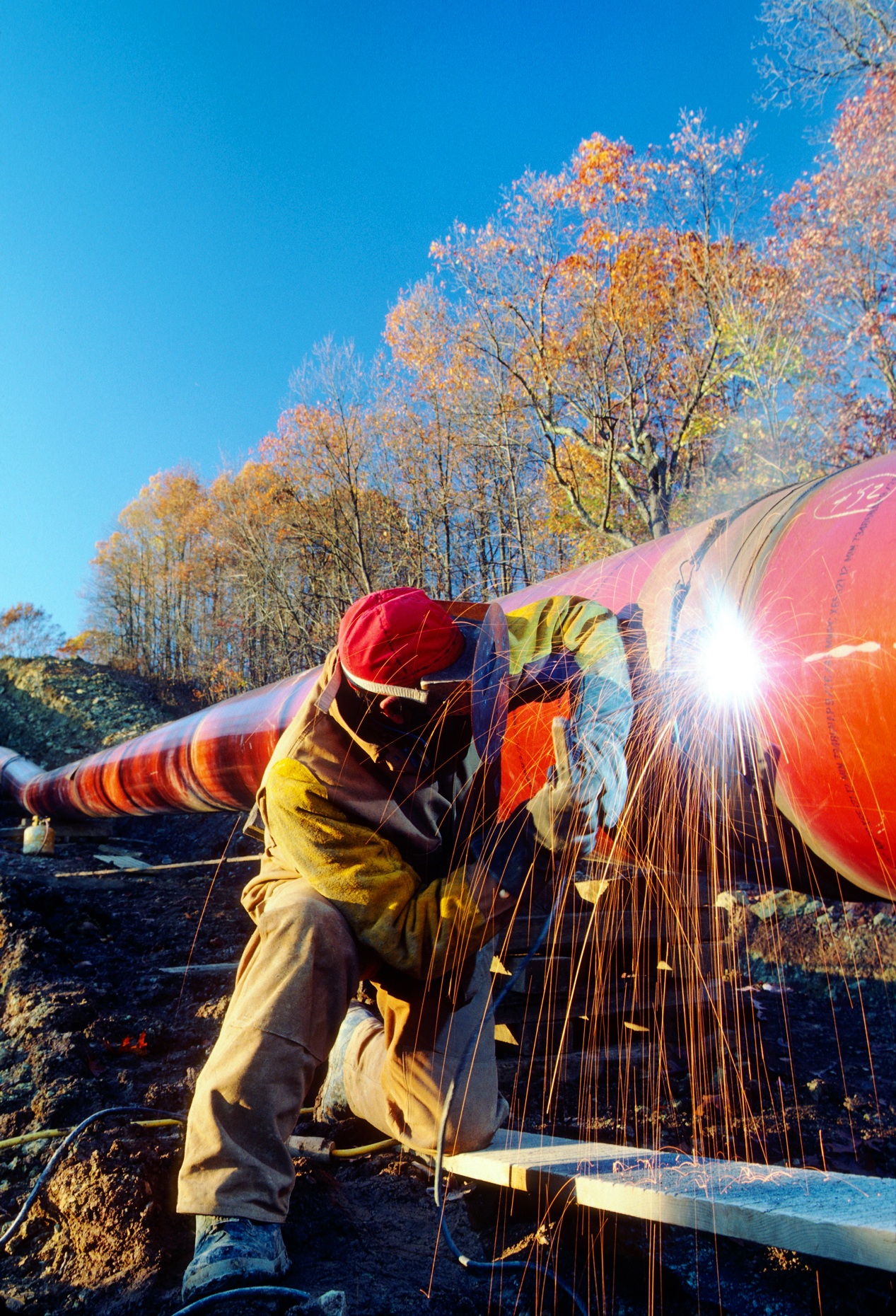 Man welding a pipeline seam in rural West Virginia; USA