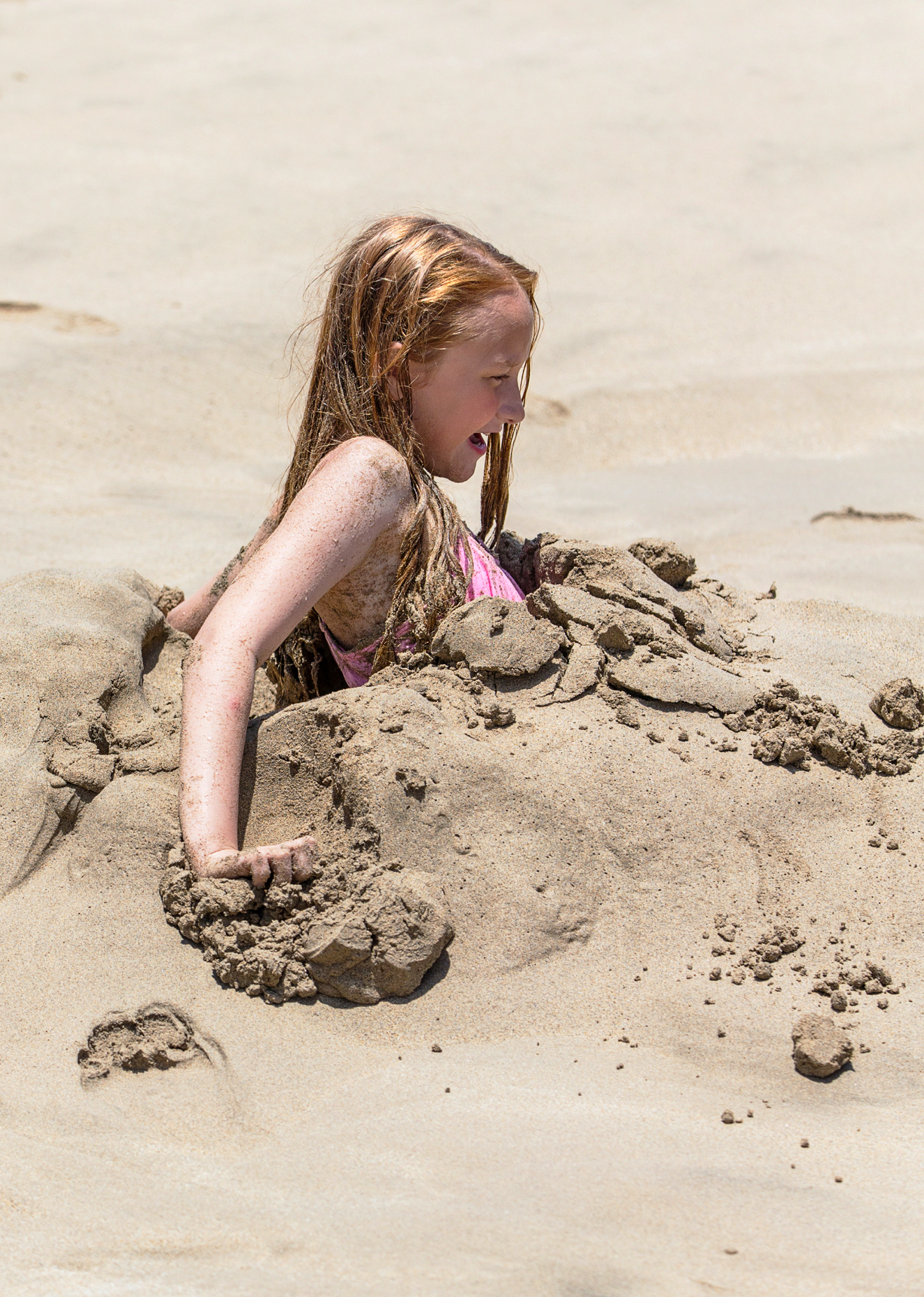 Young girl playing in sand, Hapuna Beach, Kohala Coast, Hawai