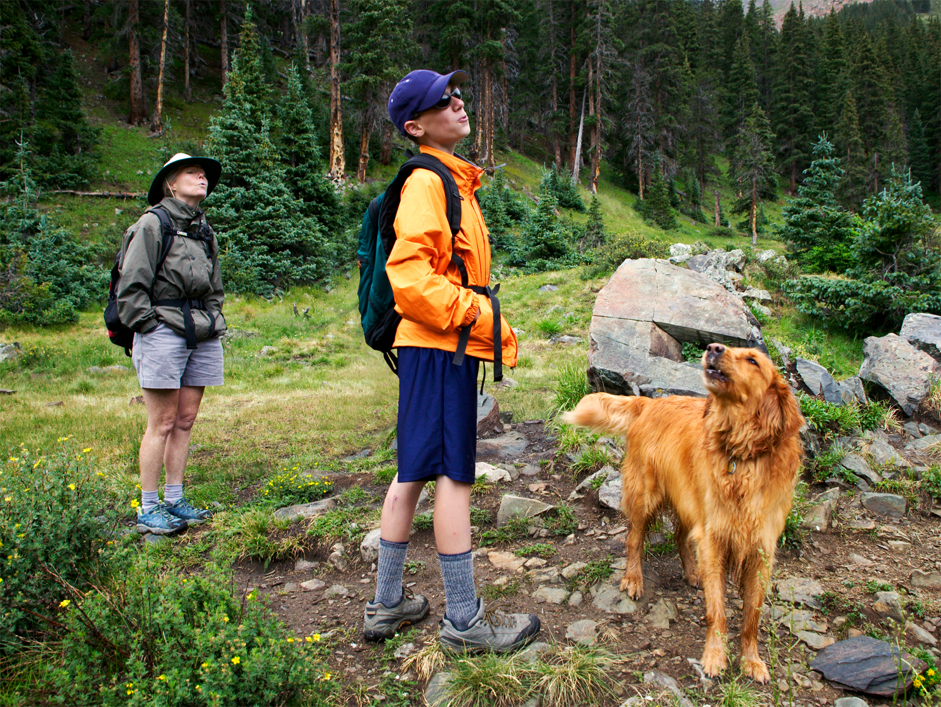 Golden Retriever dog, teenage boy and middle age female hiker all sing near Taos, New Mexico