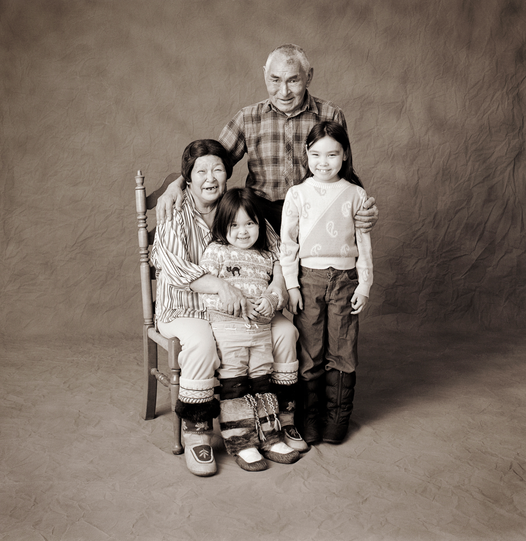 Black & white studio portrait of Inuit family in a photography studio in Iqaluit, Nunavut, Canada