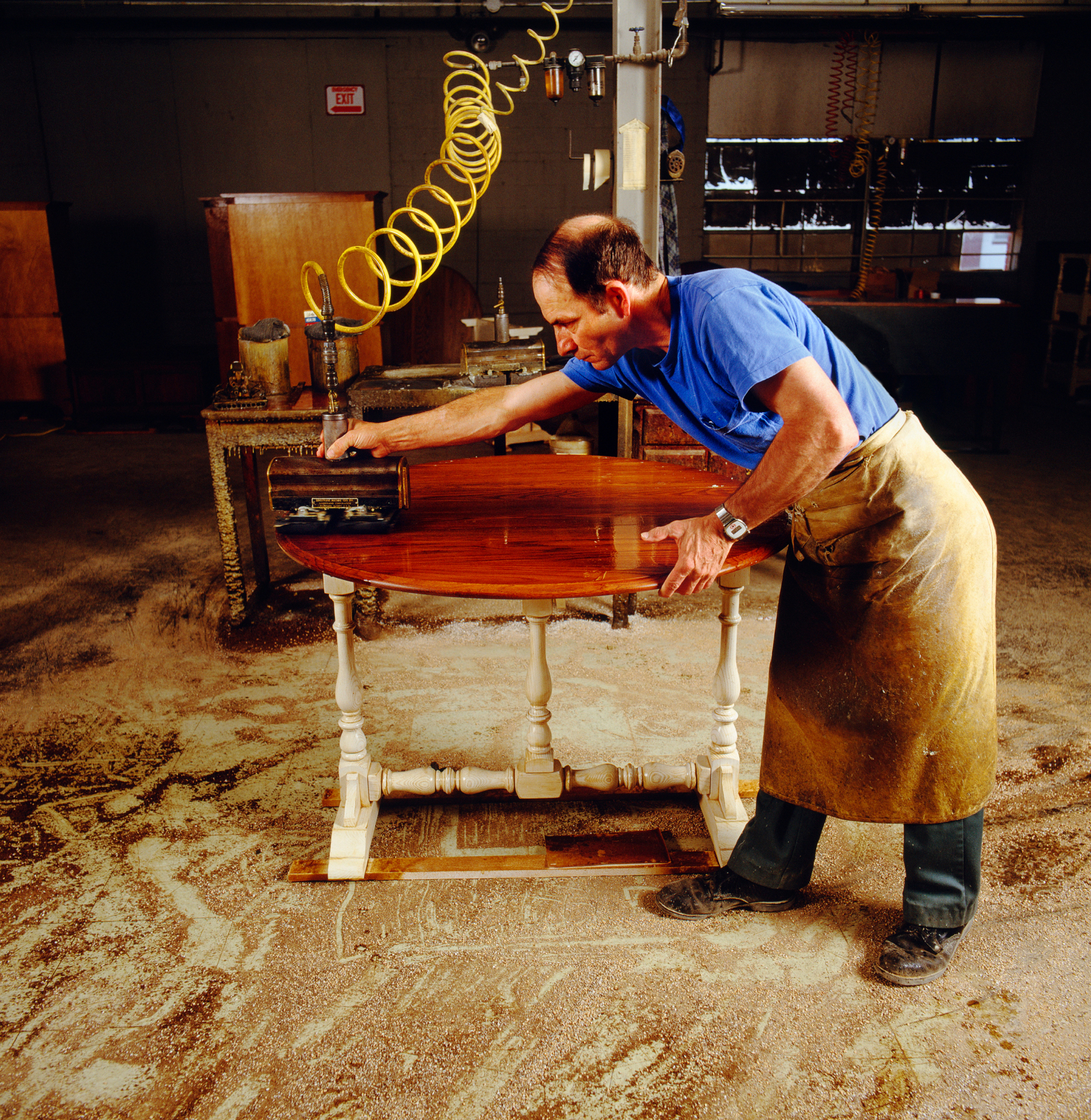 WORKER DOES THE FINAL POLISHING TO A PIECE OF FURNITURE, PENNSYL
