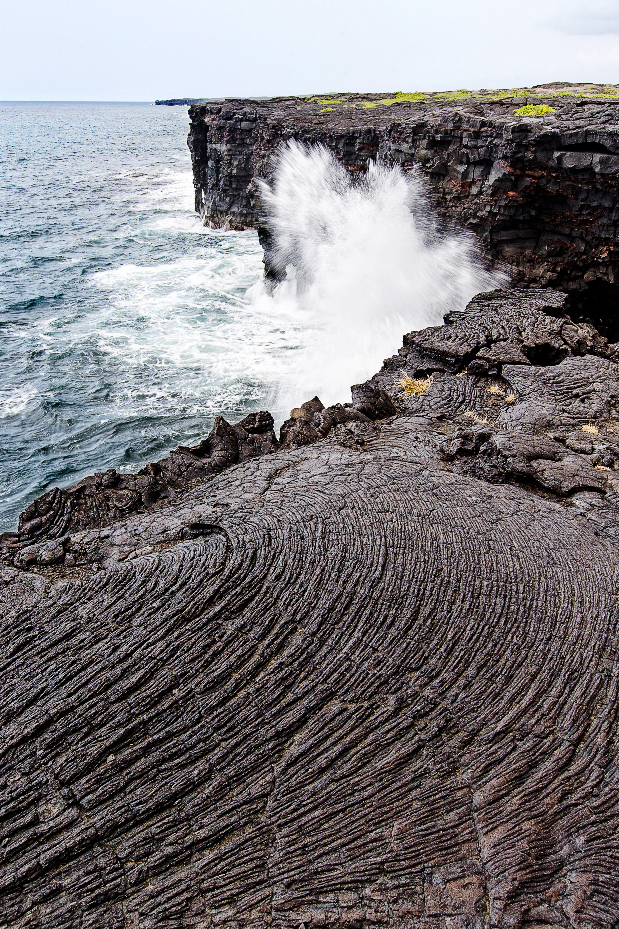 Pacific Ocean waves crash against volcanic rock, Hawai