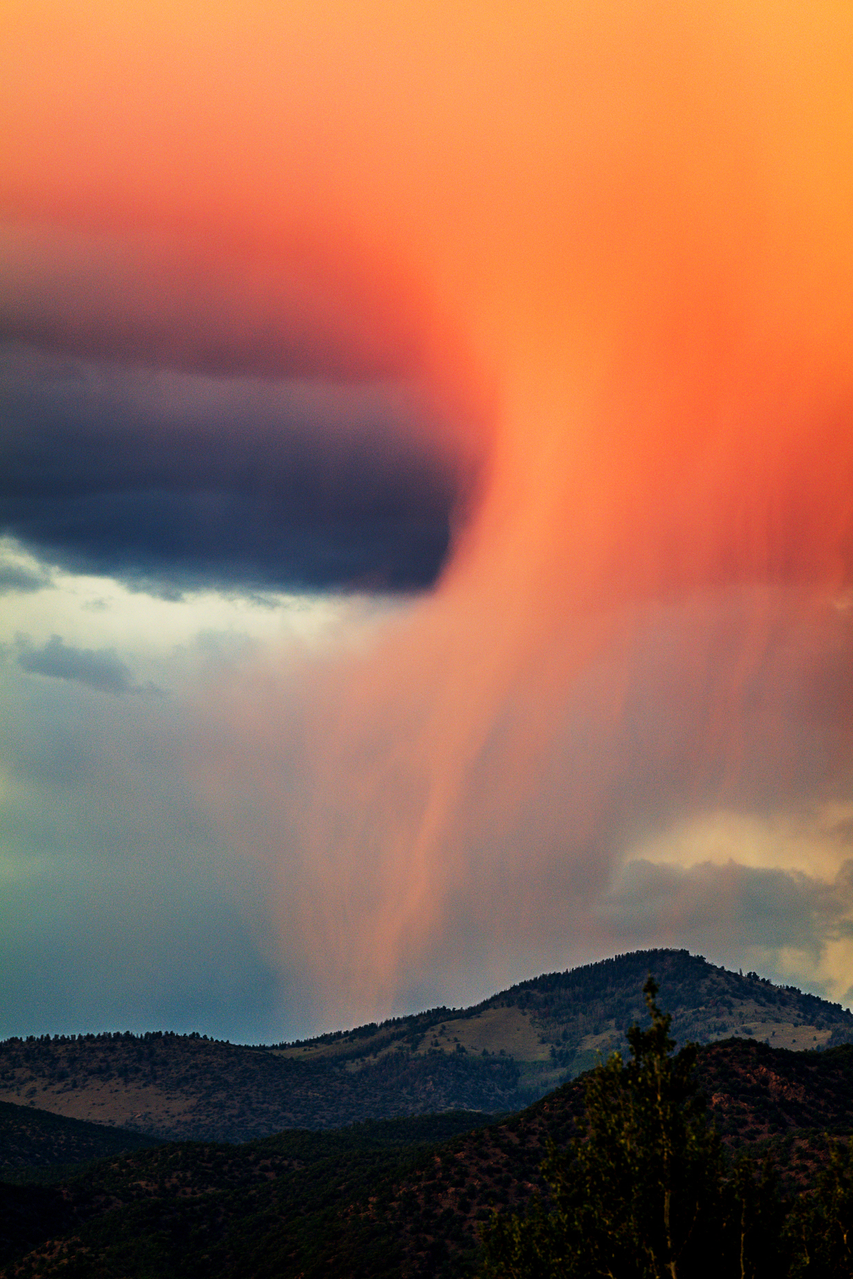Pink rainclouds reflect sunset over the Rocky Mountains; Salida; Colorado; USA