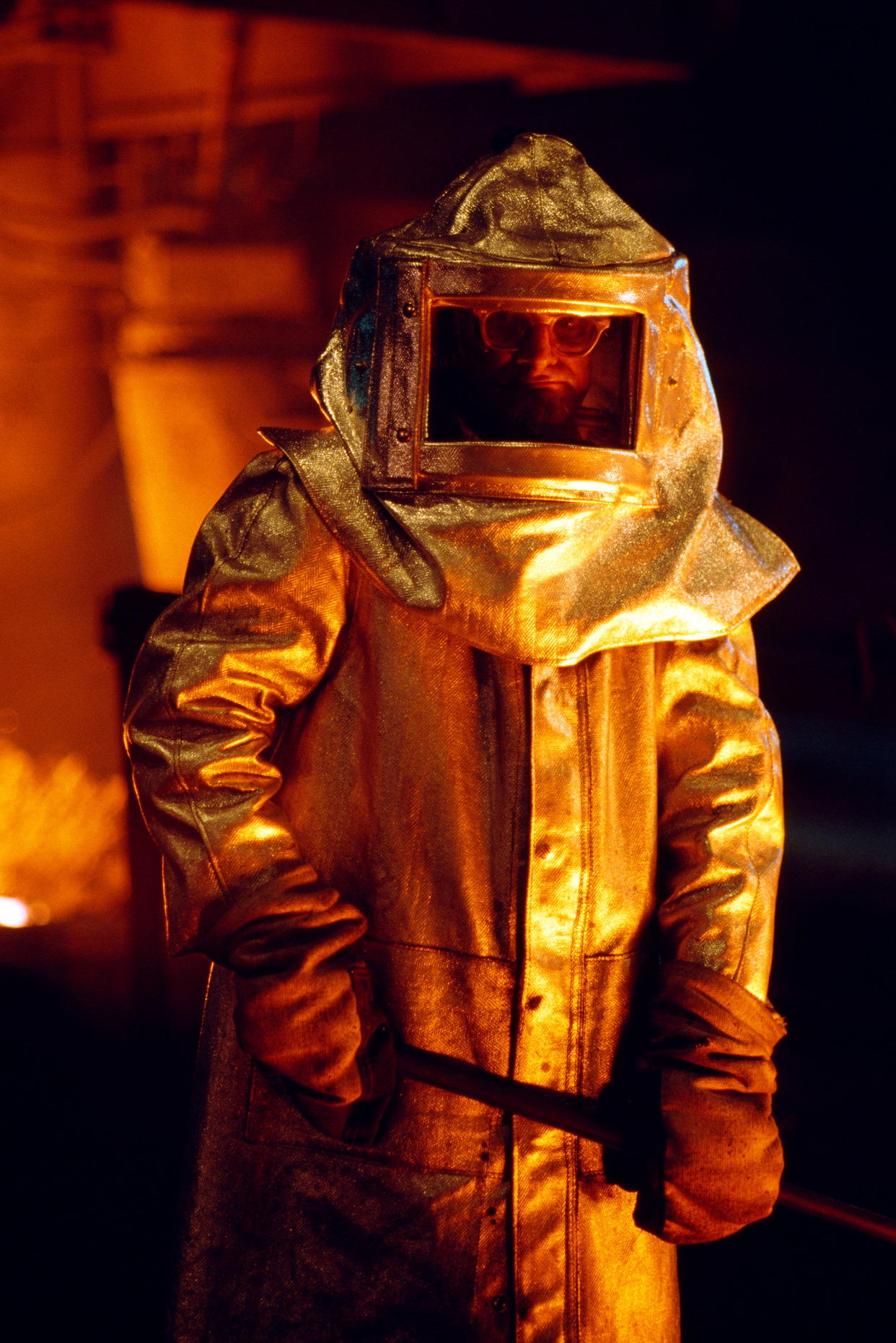 Steel worker pauses for a photograph next to a glowing hot blast furnace, US Steel (USX), Edgar Thomson Plant, Pittsburgh, Pennsylvania, USA