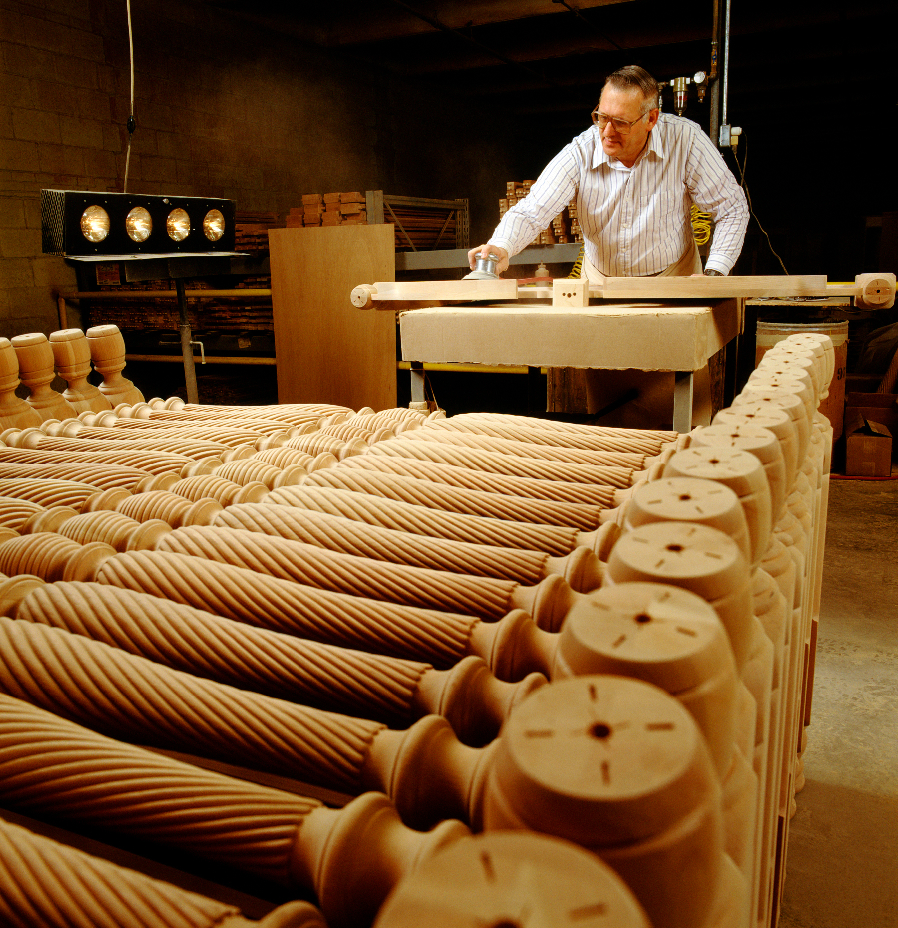 WORKER DOES THE FINAL SANDING TO A PIECE OF FURNITURE, PENNSYLVA