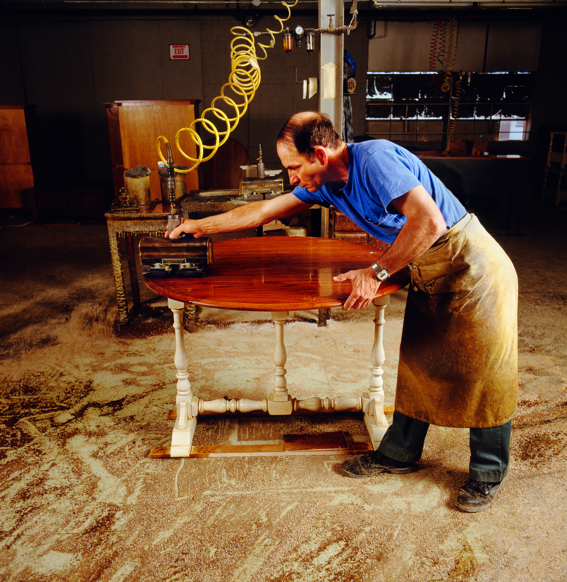 WORKER DOES THE FINAL POLISHING TO A PIECE OF FURNITURE, PENNSYL