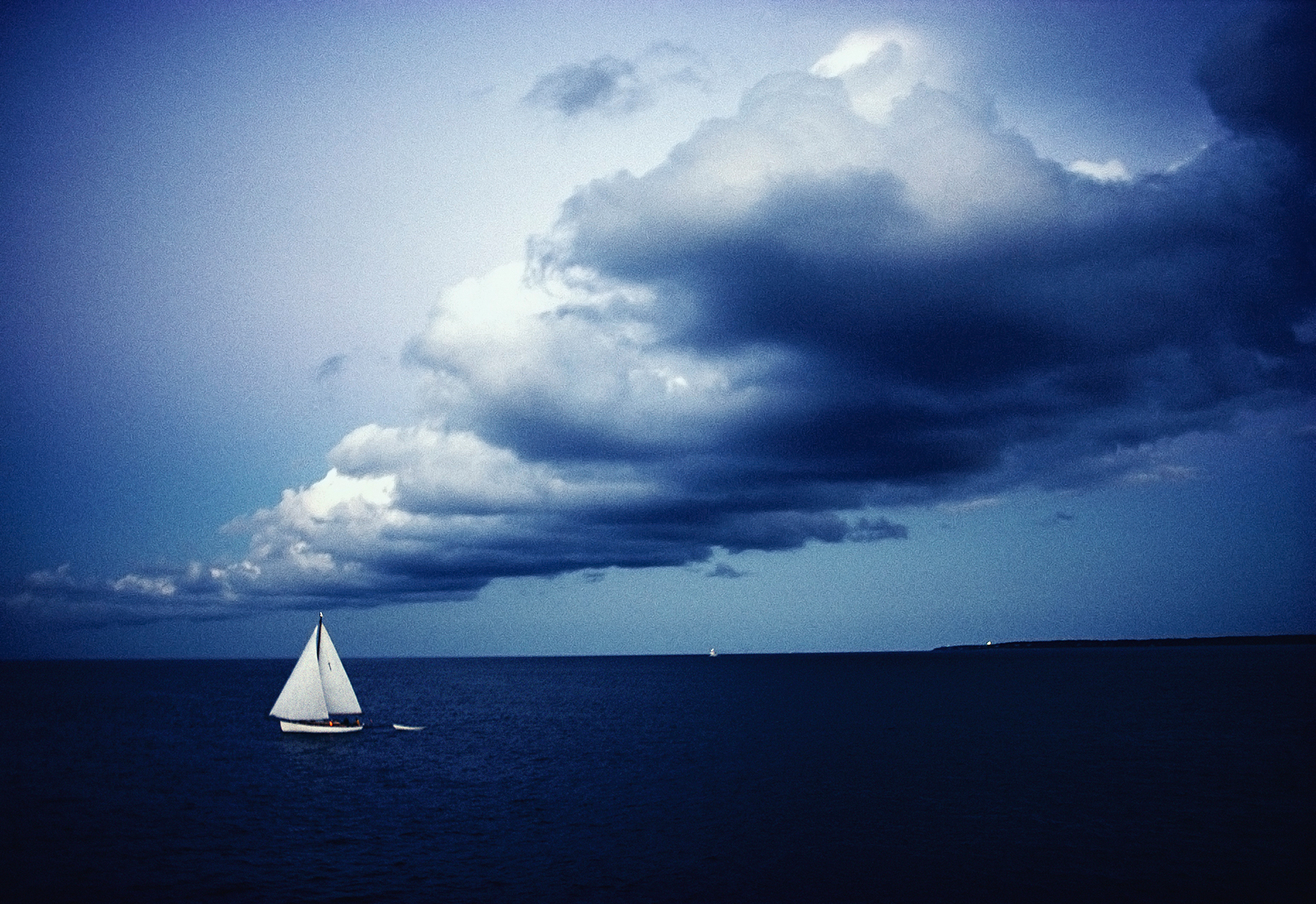 Dramatic dusk sky and sailboat off Martha