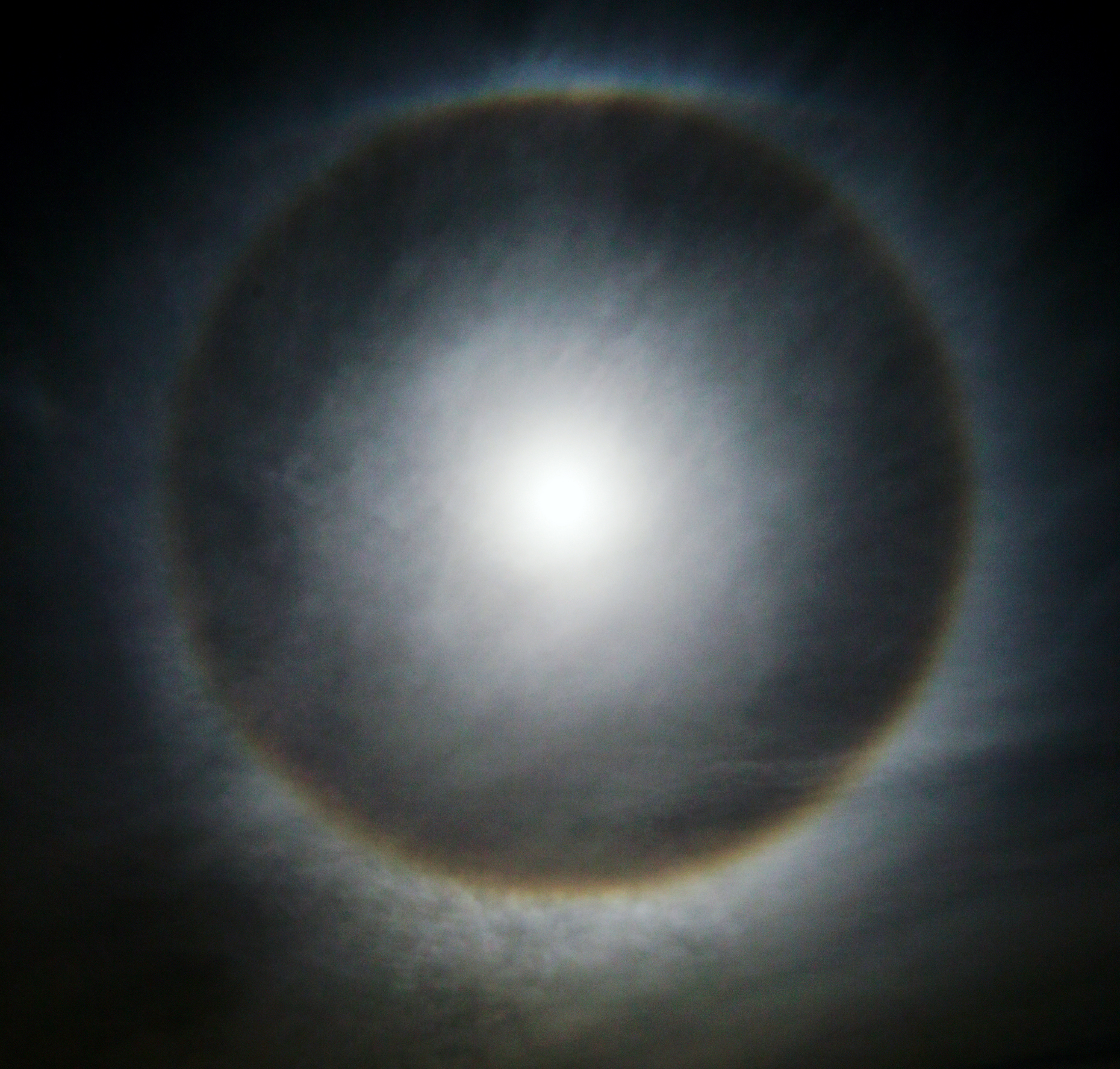 Full moon with round "sun dog", or halo circle over Rocky Mountains, Salida, Colorado, USA