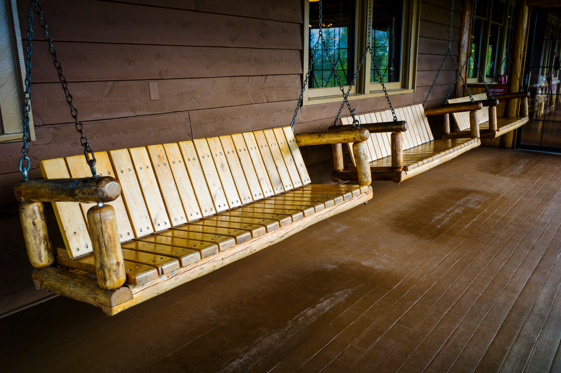Wooden swing seats on porch of historic Grand Lake Lodge; near Rocky Mountain National Park; Colorado; USA