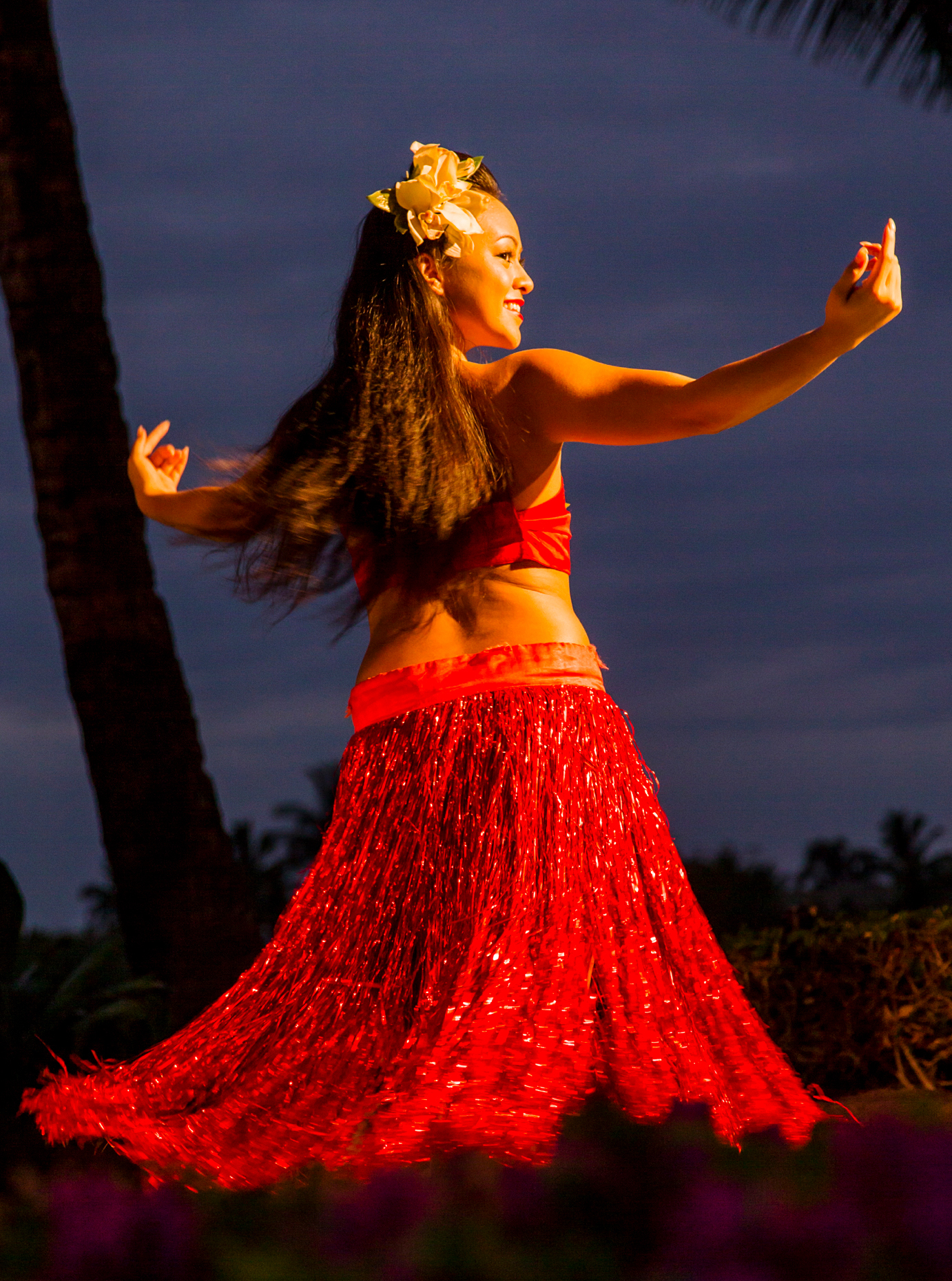 Beautiful young native woman performing traditional dance at Luau, Big Island, Hawai