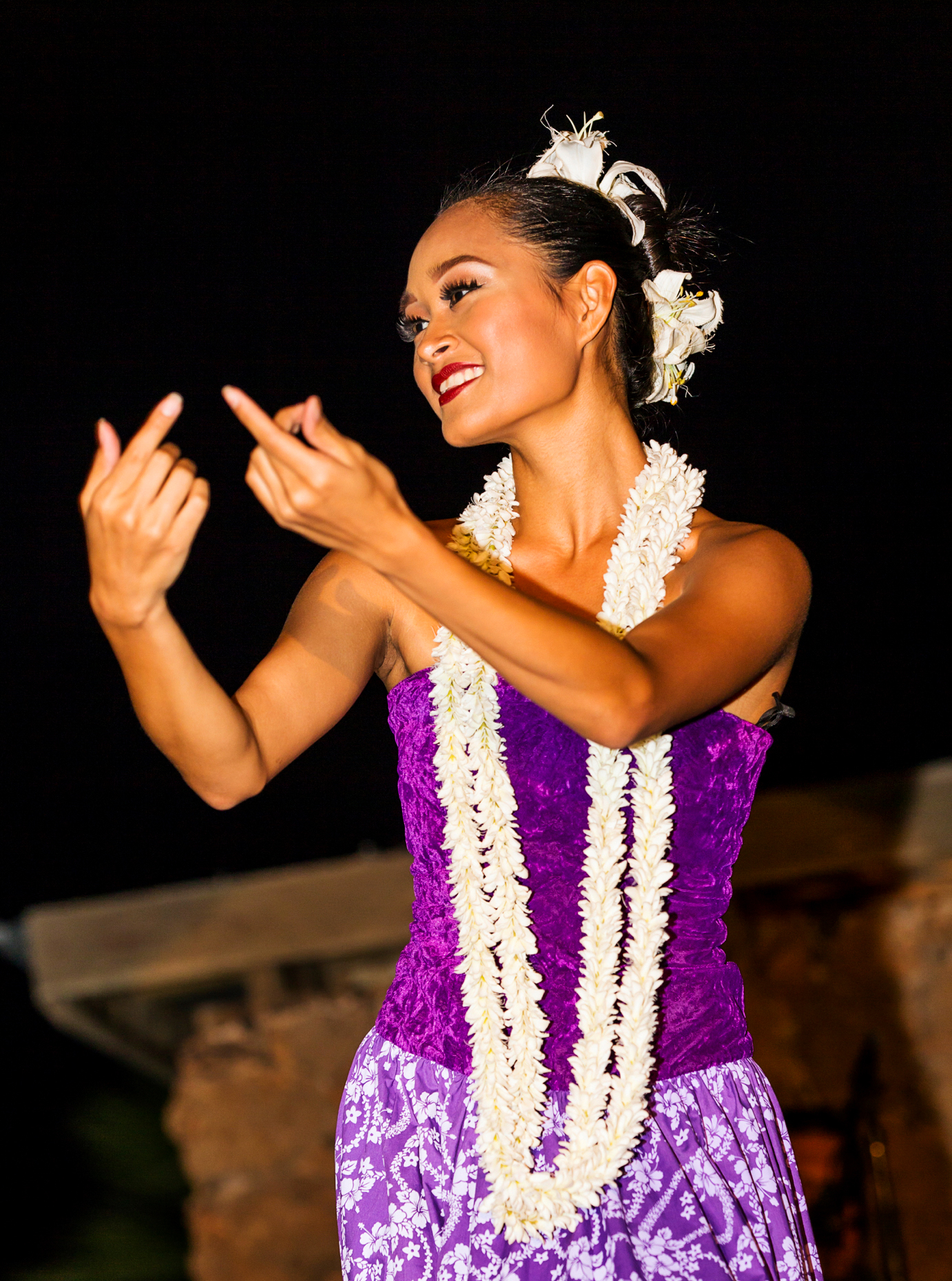 Beautiful young native woman performing traditional dance at Luau, Big Island, Hawai