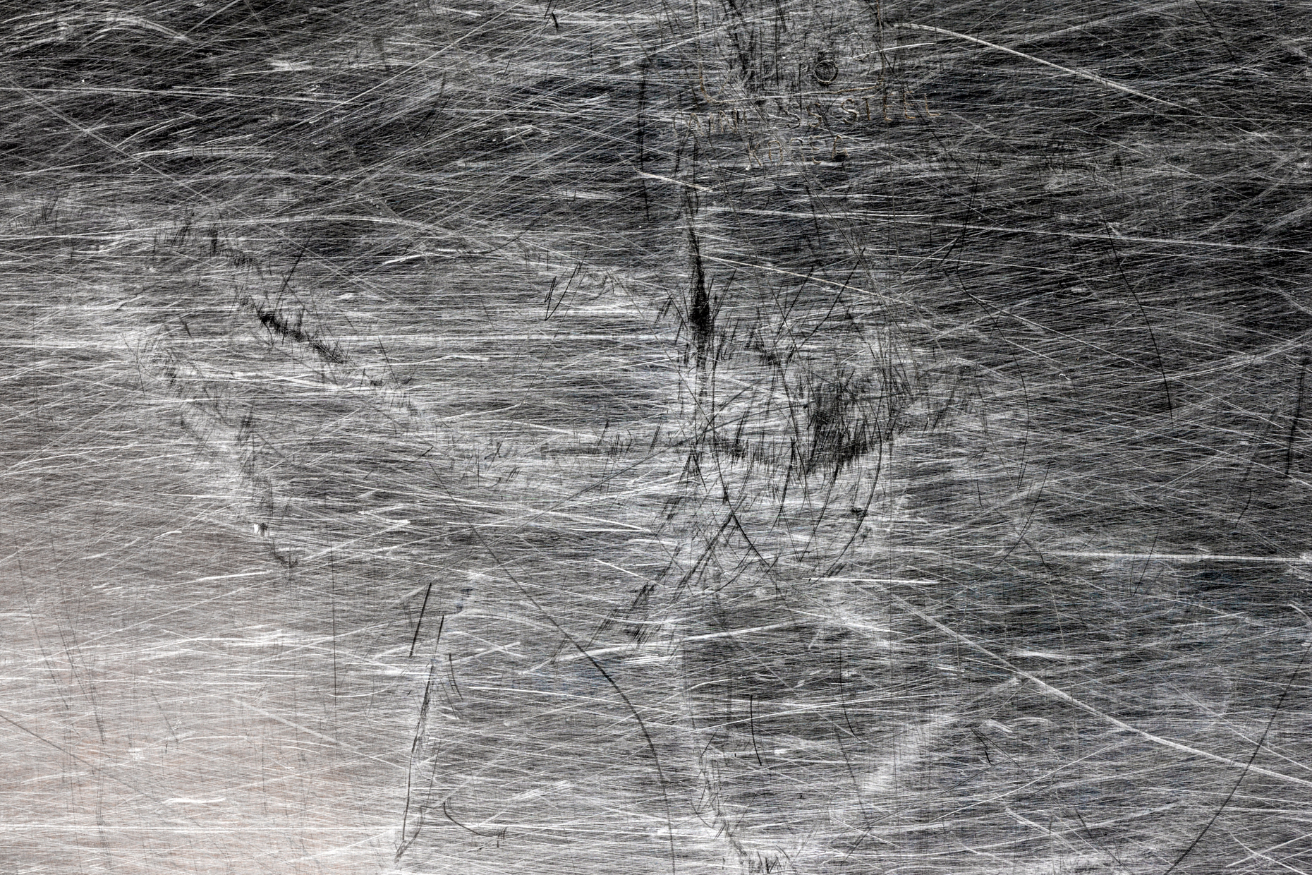 Close-up studio photograph of texture in metal baking pan