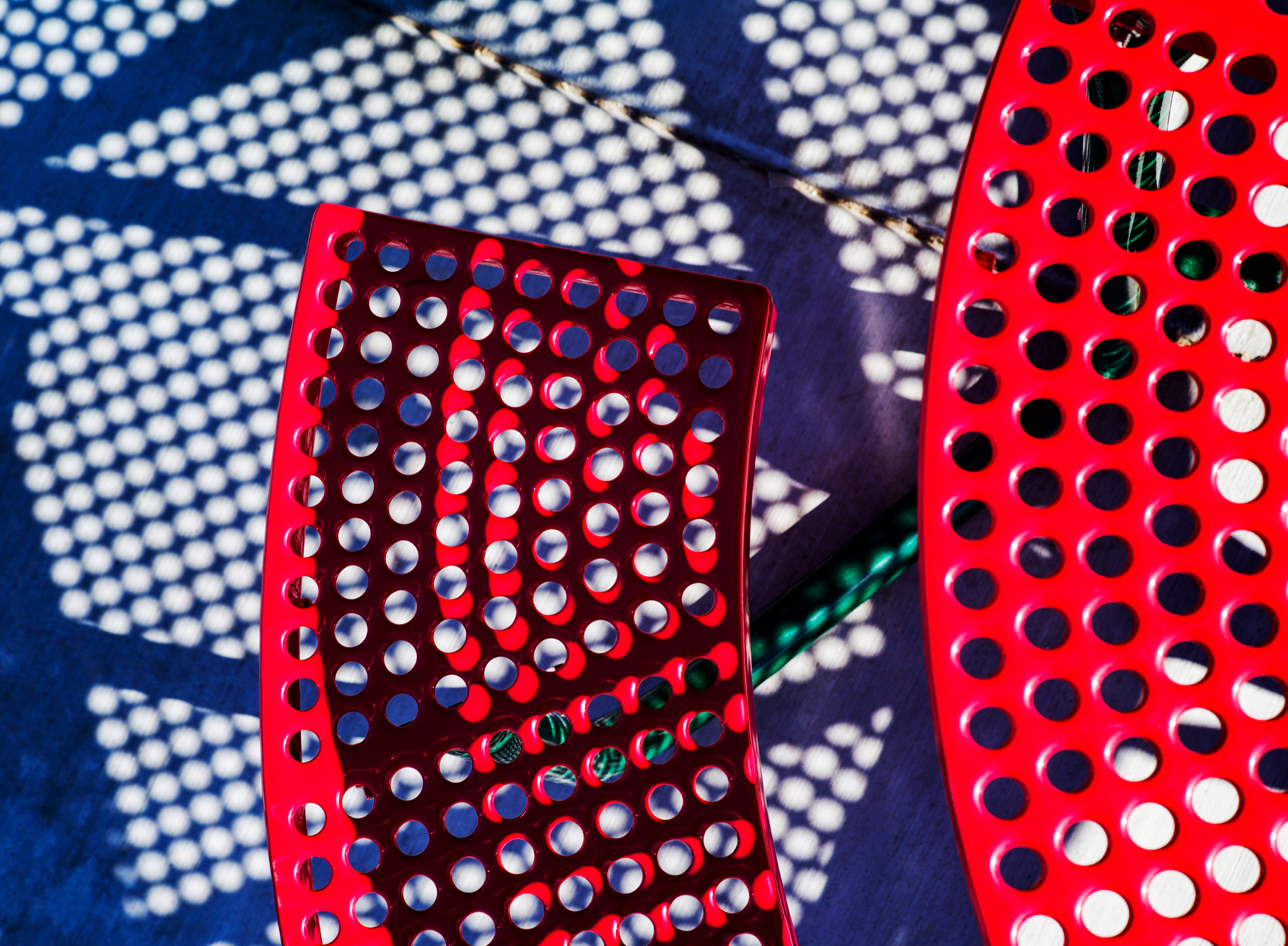 Abstract photograph of colorful red patio table and bench
