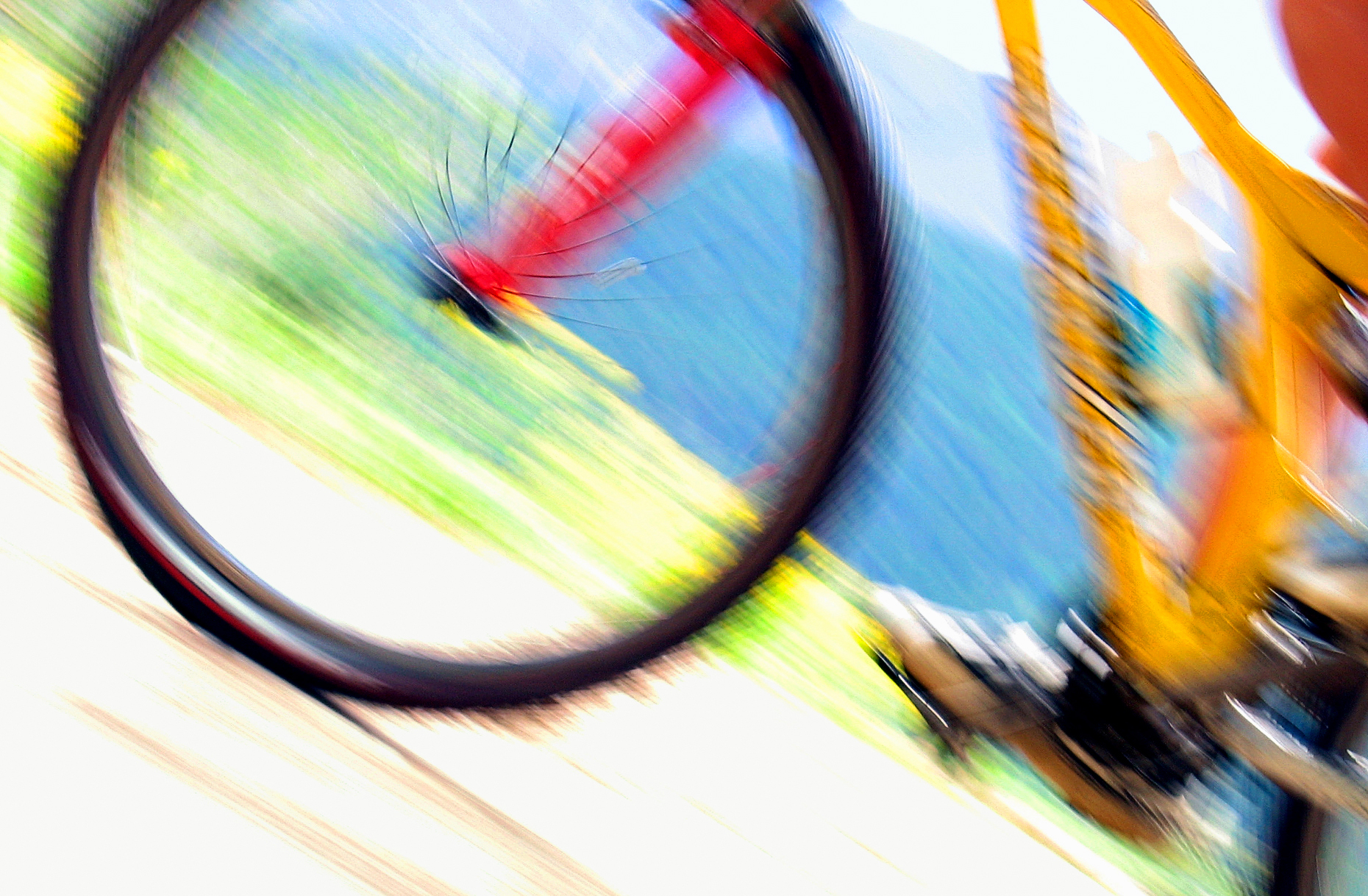 Abstract close up of a colorful front wheel of a mountain bike spinning in a blur of motion