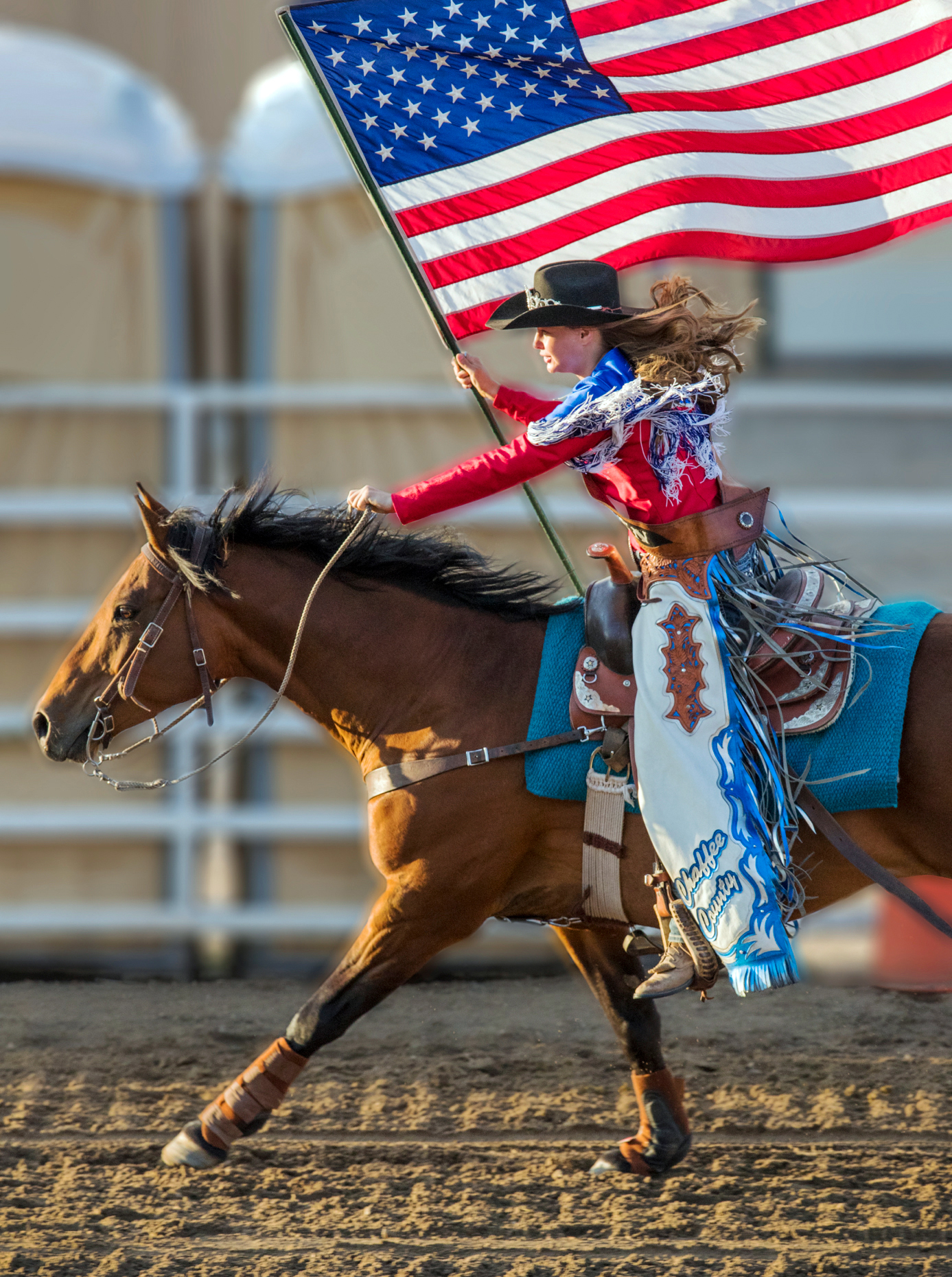 Rodeo Queen on horseback with American Flag; Chaffee County Fair & Rodeo, Salida, Colorado, USA