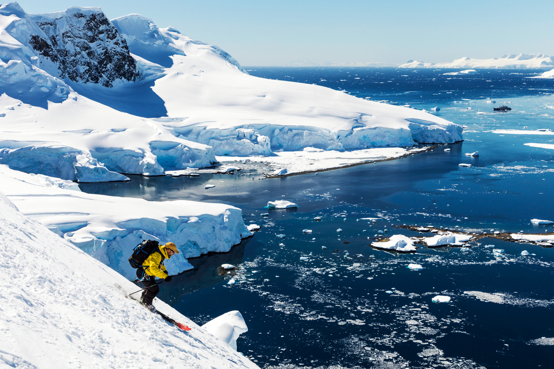 Alpine ski mountaineer skiing downhill in Antarctica; Nansen Island